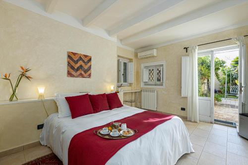 a bedroom with a bed with a tray of food on it at B&B Sant'Agostino in Palermo