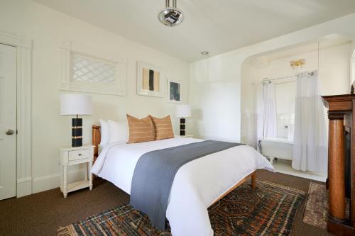 a white bedroom with a large bed and a window at Sonder Wellborn in Orlando