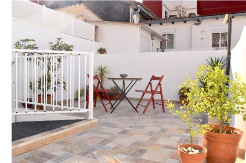 a balcony with a white fence and plants at Casa Cabanyal in Valencia