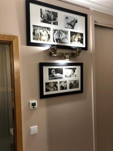 a bathroom with three pictures on the wall at HENRI'S APARTMENTS - Pátio do Convento in Lagos