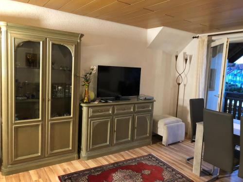 a living room with a television on a entertainment center at Ferienwohnung Bodensee LA in Langenargen