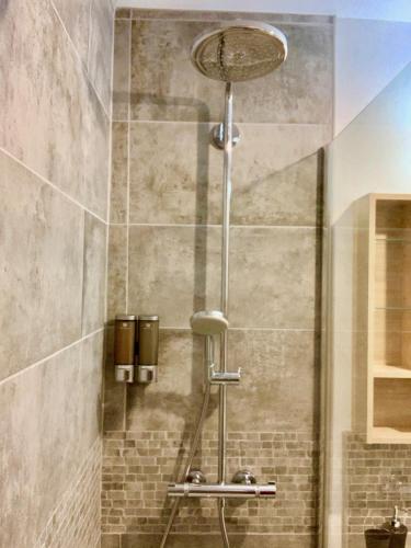 a shower in a bathroom with a shower at La charmeraie in Compiègne