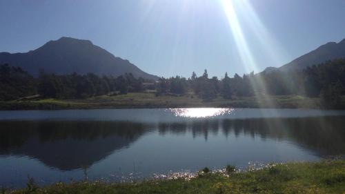a lake with the sun shining on the water at Klipfontein Rustic Farm & Camping in Tulbagh