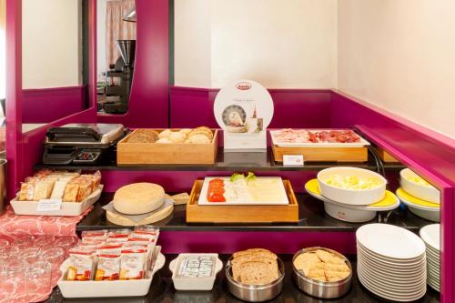 a display case with many different types of food at Augustus Hotel in Biella