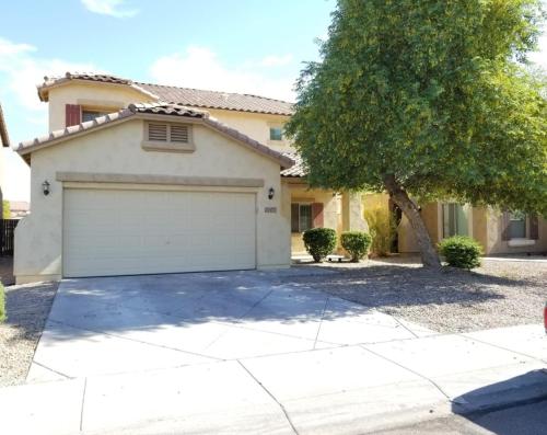 a house with a garage and a tree at Phoenix I, Minutes to Airport and Downtown in Phoenix
