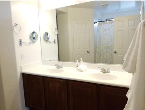 a bathroom with a sink and a large mirror at Phoenix I, Minutes to Airport and Downtown in Phoenix