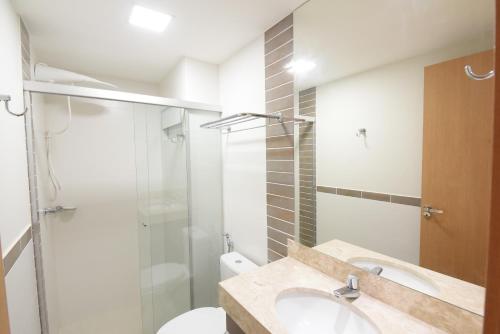 a bathroom with a toilet and a sink and a shower at Park Veredas Resort in Rio Quente