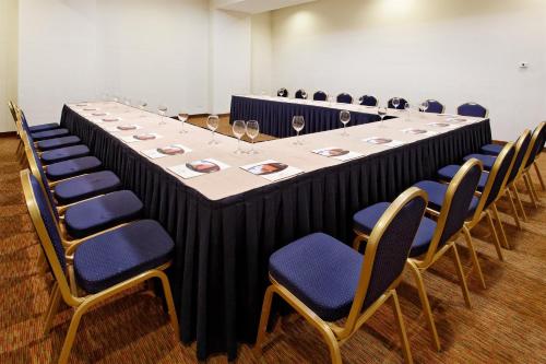 a long table in a room with chairs and wine glasses at Crowne Plaza Monterrey Aeropuerto by IHG in Monterrey