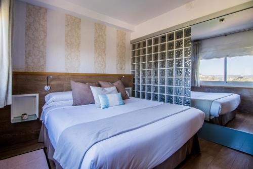 a bedroom with a large white bed and a window at Lux Isla in Talamanca