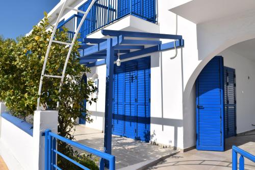 a blue door on the side of a white building at Villa St. Nicolas 8 - Protaras in Protaras