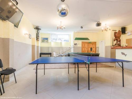 a ping pong table in the middle of a room at Pokoje Gościnne SŁONECZKO Władysławowo in Władysławowo