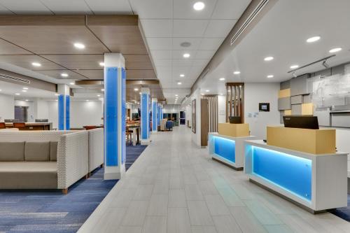 an office lobby with blue columns and desks at Holiday Inn Express & Suites Plano East - Richardson by IHG in Plano