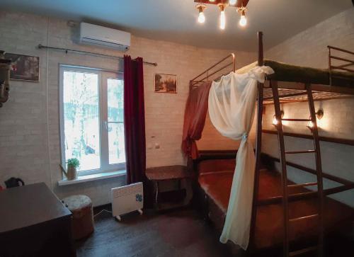 a bedroom with two bunk beds and a window at Night in Magic Villins Book in Petrovo