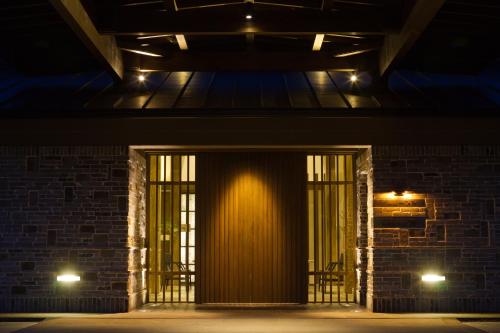 a hallway of a brick building at night at Yufuin Bettei Itsuki in Yufuin