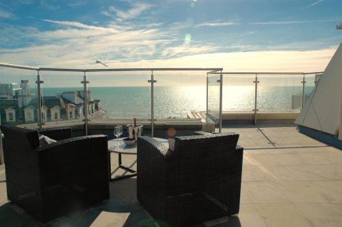 a balcony with a view of the ocean at Airhost's Brighton's Best Green Diamond Escape with Sea Views in Brighton & Hove