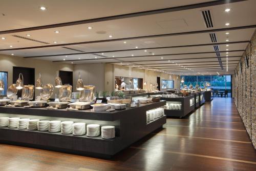 a restaurant with a buffet line with dishes at Tokyo Dome Hotel in Tokyo