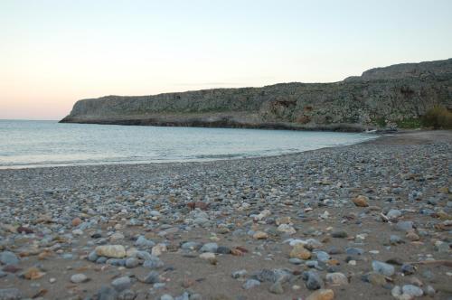 a rocky beach with the ocean in the background at Little Blue in Káto Zákros
