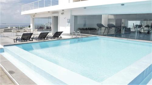 a swimming pool on the roof of a building at Lincoln Suite in Santo Domingo