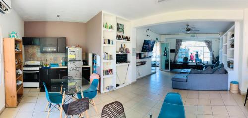 a kitchen and living room with a table and chairs at Hostal Bucerias in Bucerías