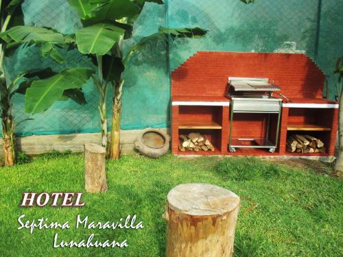a doll house with a stove in a yard at Hotel Septima Maravilla Lunahuana in Lunahuaná