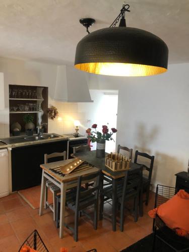 a kitchen with a table with chairs and a kitchen with a tableablish at The Castle House - Unique Places in Óbidos
