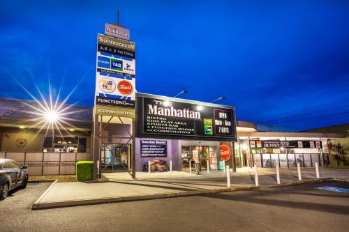 a gas station with a sign in front of it at Nightcap at Manhattan Hotel in Ringwood