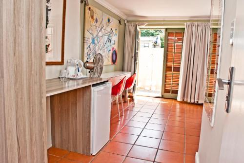 a kitchen with a counter and a tile floor at Funky Town in Jeffreys Bay
