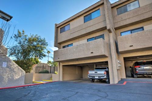 a building with a truck parked in a parking lot at 4 Mi to ASU Lake-View Tempe Condo with Pool Access in Tempe