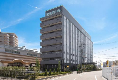 a building with a sign on the side of it at Hotel Route-Inn Osaka Kishiwada -Higashikishiwada Ekimae Kansai Airport- in Kishiwada