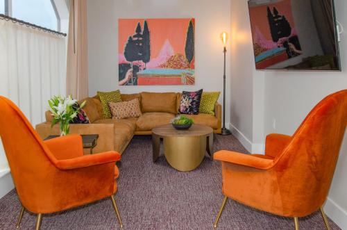 a living room with a couch and two chairs at The Dundee - A Trace Hotel in Dundee