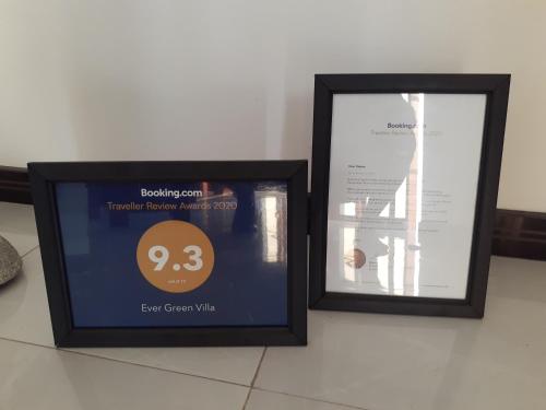 two framed pictures sitting next to each other on a table at Ever Green Villa in Negombo