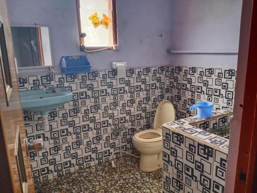 a bathroom with a toilet and a sink at Elen Homestay by ABM in Bromo