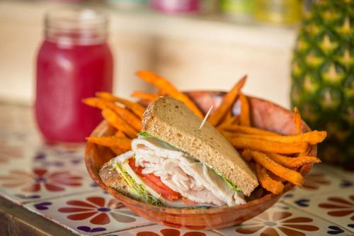 a sandwich and french fries in a bowl with a ketchup at Hotel Metropole in Avalon