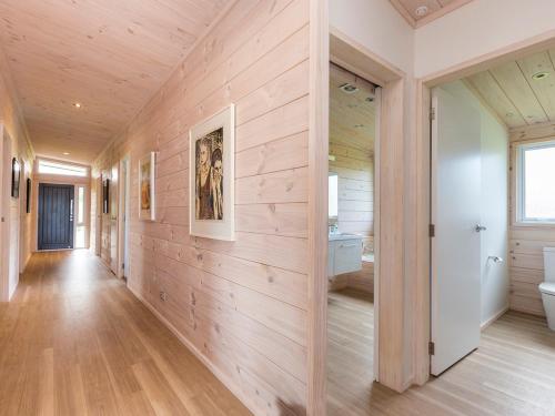 a hallway of a home with wood paneled walls at Beachfront Escape - Snells Beach Holiday Home in Snells Beach