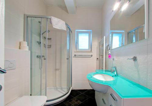 a bathroom with a sink and a glass shower at Villa Katarina 2nd Floor Apartments in Dubrovnik