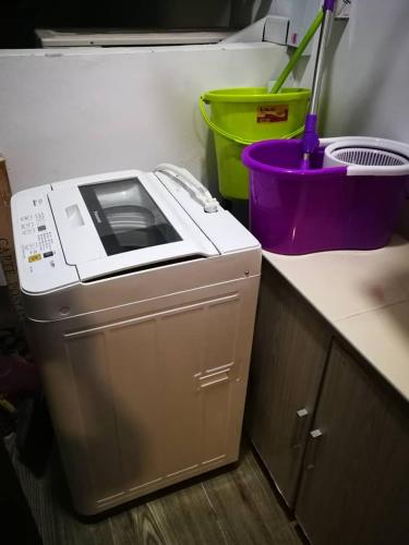 a microwave sitting on top of a kitchen counter at Perfect Getaway @Vivacity in Kuching