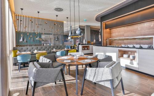 a dining room with a table and chairs at Holiday Inn - Villingen - Schwenningen by IHG in Villingen-Schwenningen