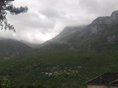 a valley in the mountains with a town in the middle at Lakis Rooms in Papigko