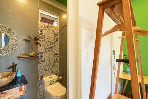 a bathroom with a toilet and a sink at An Bang Sea Adventure Homestay Hoi An in Hoi An
