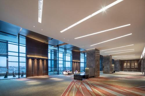 a lobby of a building with large windows at Holiday Inn Shunde, an IHG Hotel in Shunde