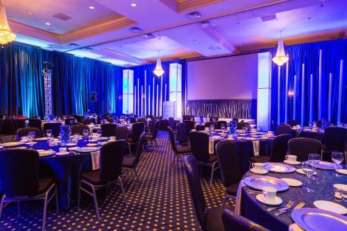 a banquet hall with tables and chairs and blue curtains at Crowne Plaza Hotel Portland-Downtown Convention Center by IHG in Portland