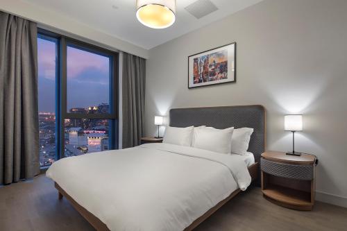 a bedroom with a large bed and a large window at RETRO 9 HOMES & SUITES ISTANBUL in Istanbul