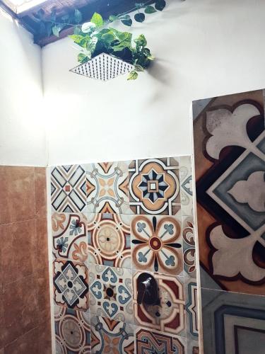 a room with mosaics on the wall of a bathroom at Havana Hideaway in Gili Trawangan