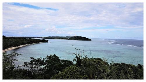 a view of the ocean with a beach in the distance at KINTANA LODGE in Ile aux Nattes