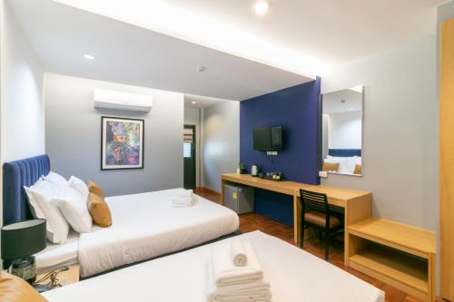 En eller flere senge i et værelse på Castle Black Bangkok