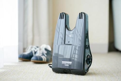 a iron is sitting on the floor in a room at Hotel Emion Kyoto in Kyoto