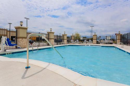 a swimming pool at a resort with a slide at Holiday Inn Express & Suites Houston - Hobby Airport Area by IHG in Houston