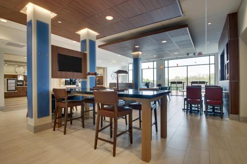 a dining room and kitchen with a table and chairs at Holiday Inn Express & Suites - Elizabethtown North by IHG in Elizabethtown