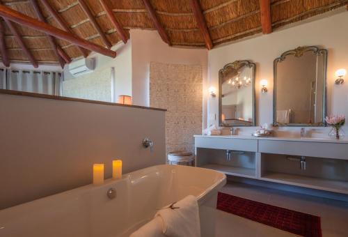 a large bathroom with a tub and a sink at Fort D'Acre in Port Alfred