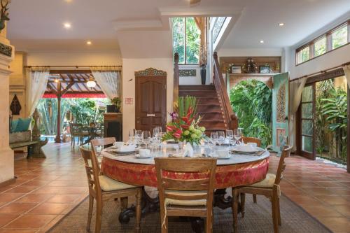 a dining room with a table and chairs at Villa Kaja by Nagisa Bali in Seminyak